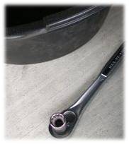 An oil pan and socket wrench.